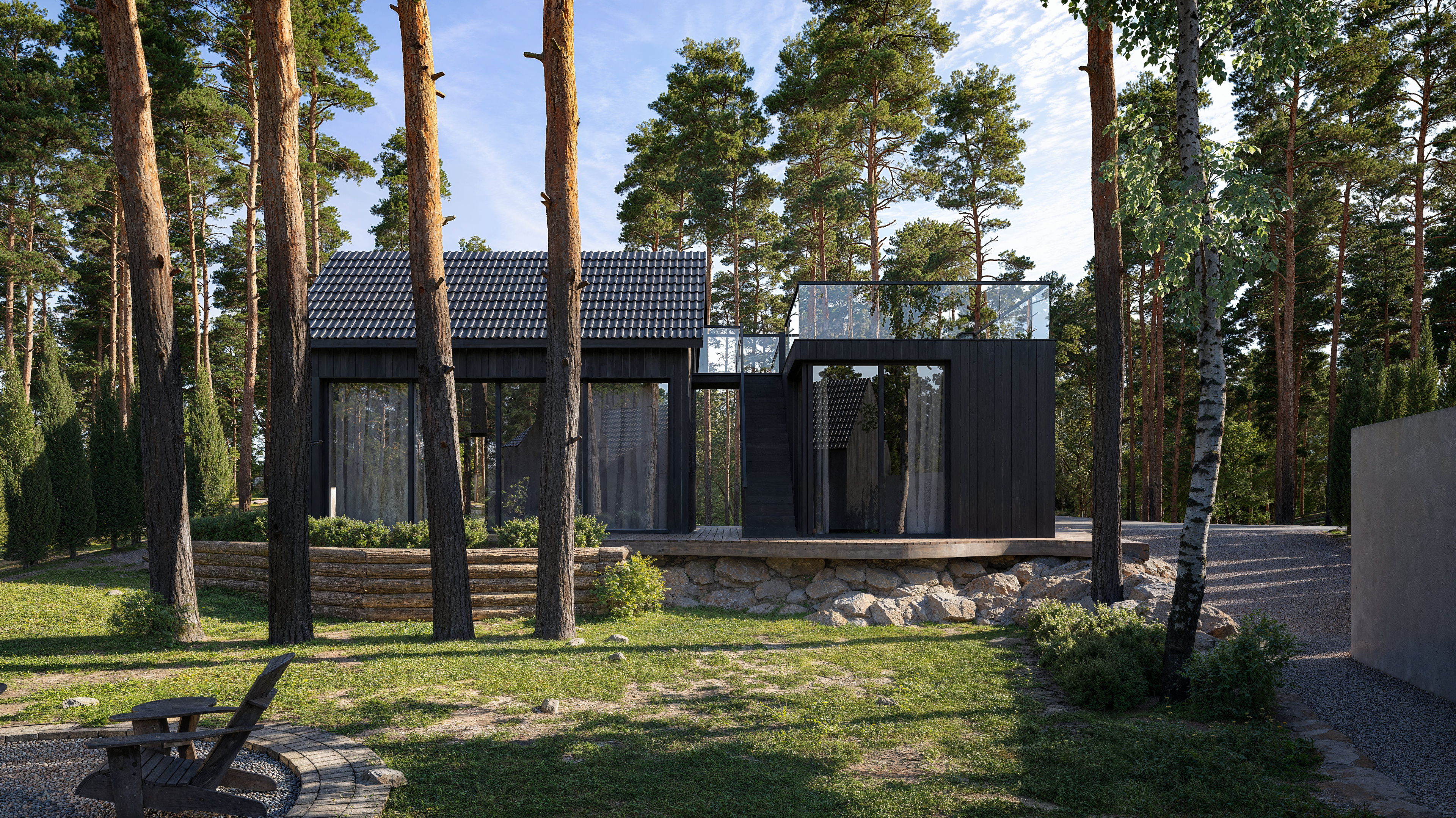 Villa Cosmos placerad i skogsmiljö med mörk fasad och stora glaspartier