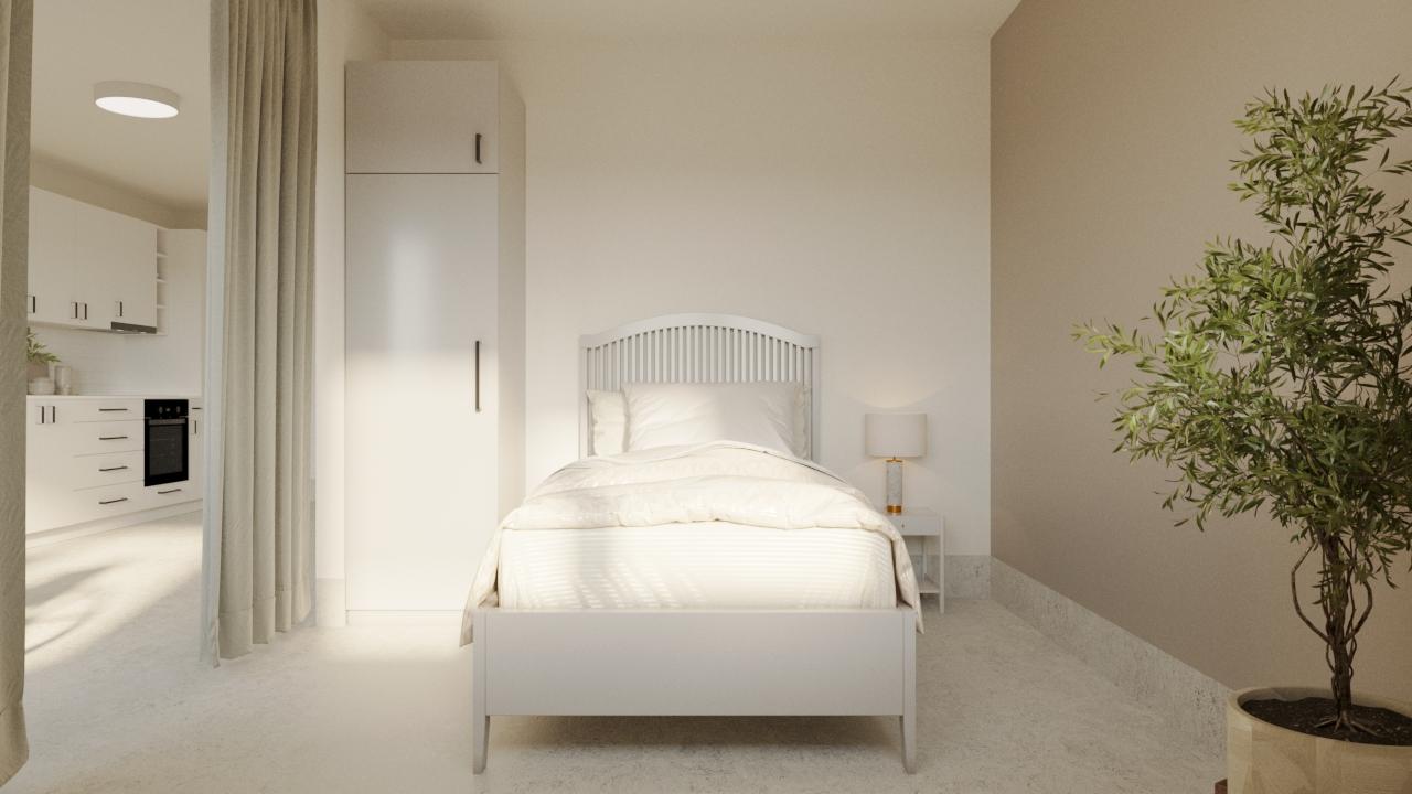 Sovrum i LSS Nocken med enkelbädd, nattduksbord och grön växt.