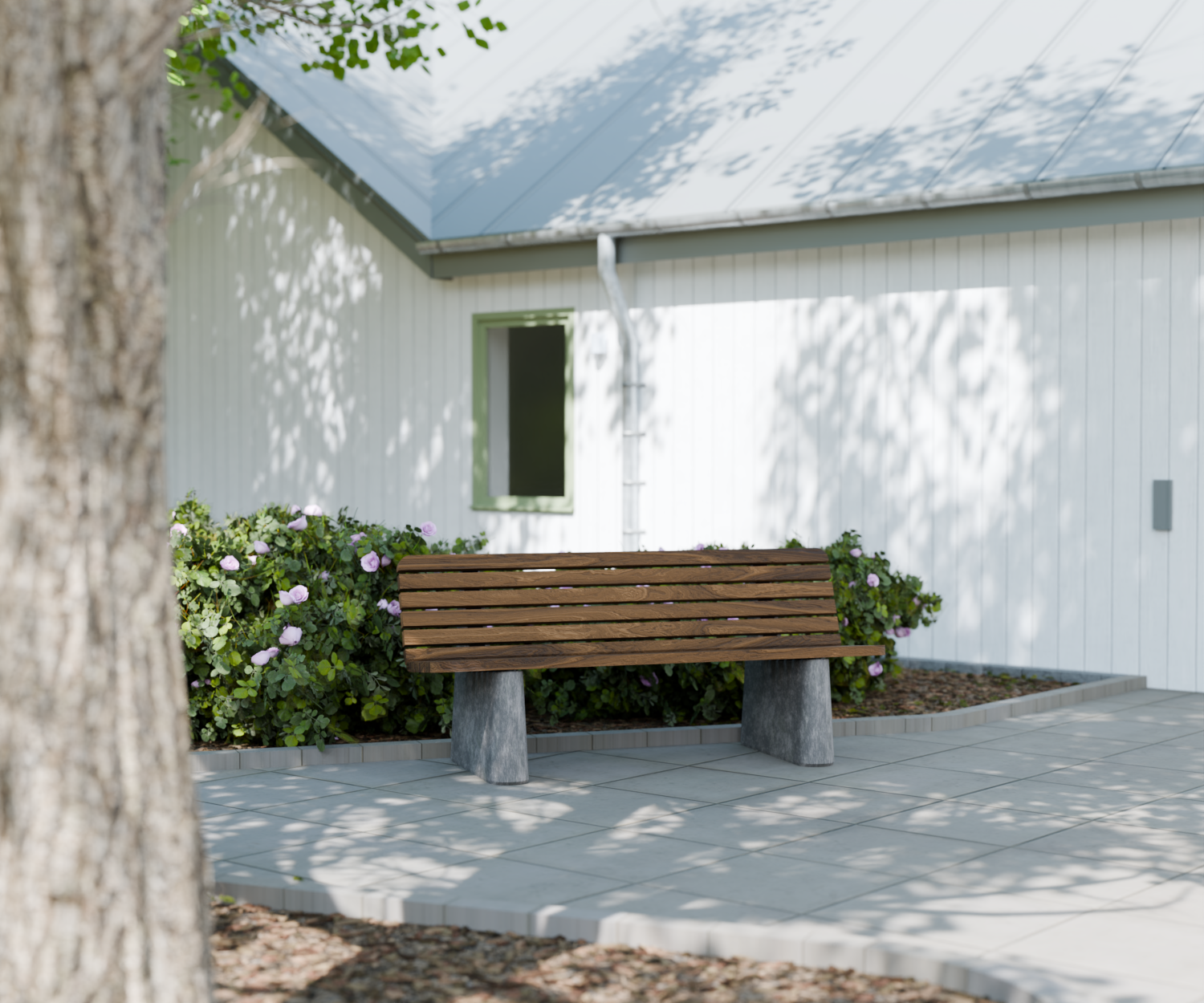 Bänkområde framför LSS Tureberg med vit fasad och planteringar i en lugn miljö.