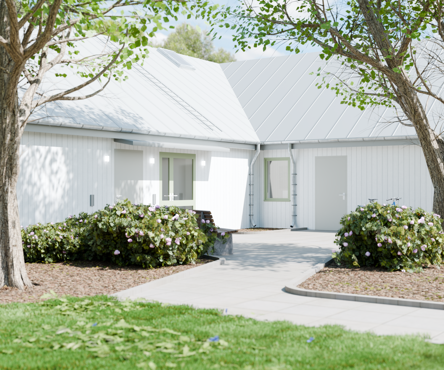 Exteriörvy av entrén till LSS Tureberg med vit fasad och buskar.